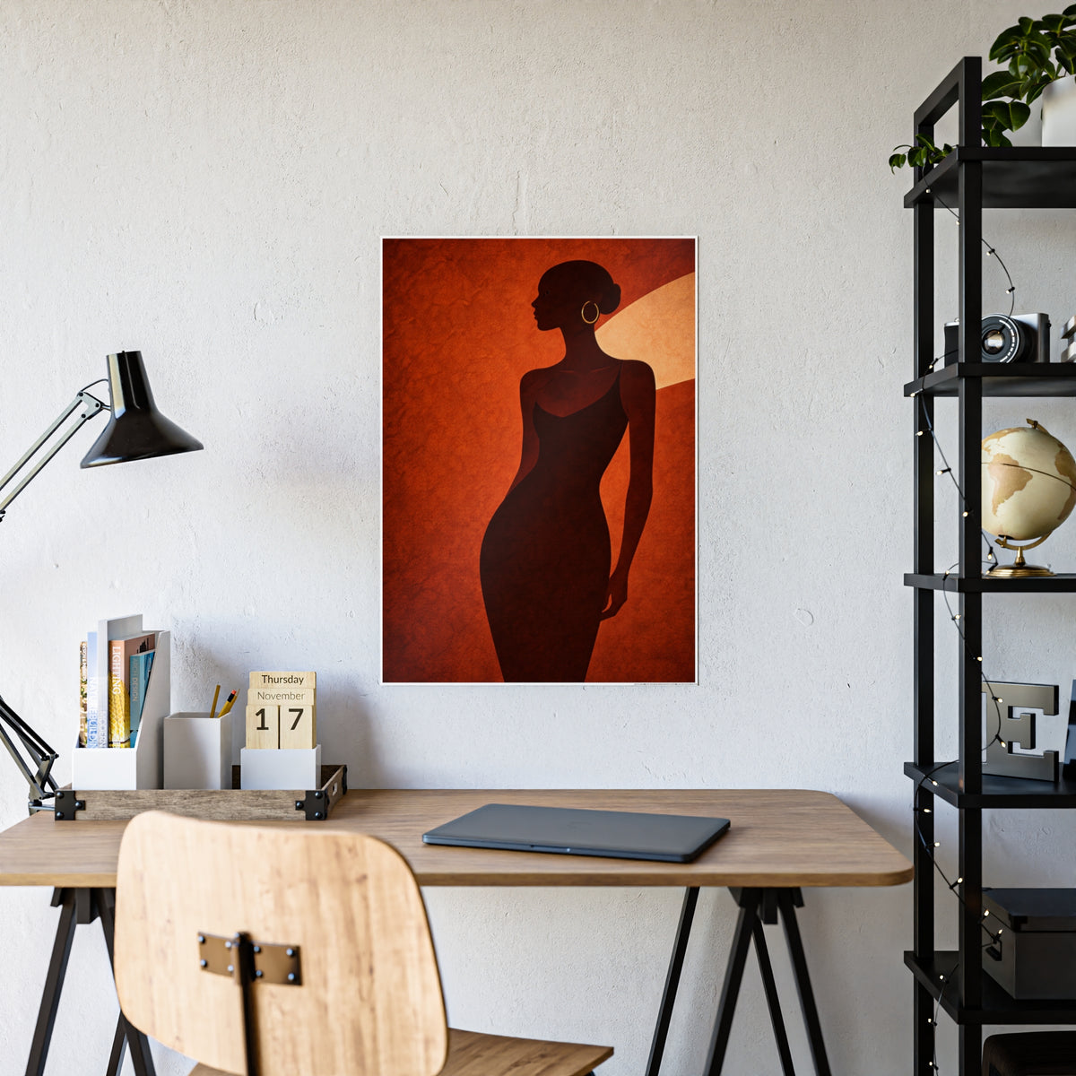 Ember poster hanging above a wooden desk in a home office